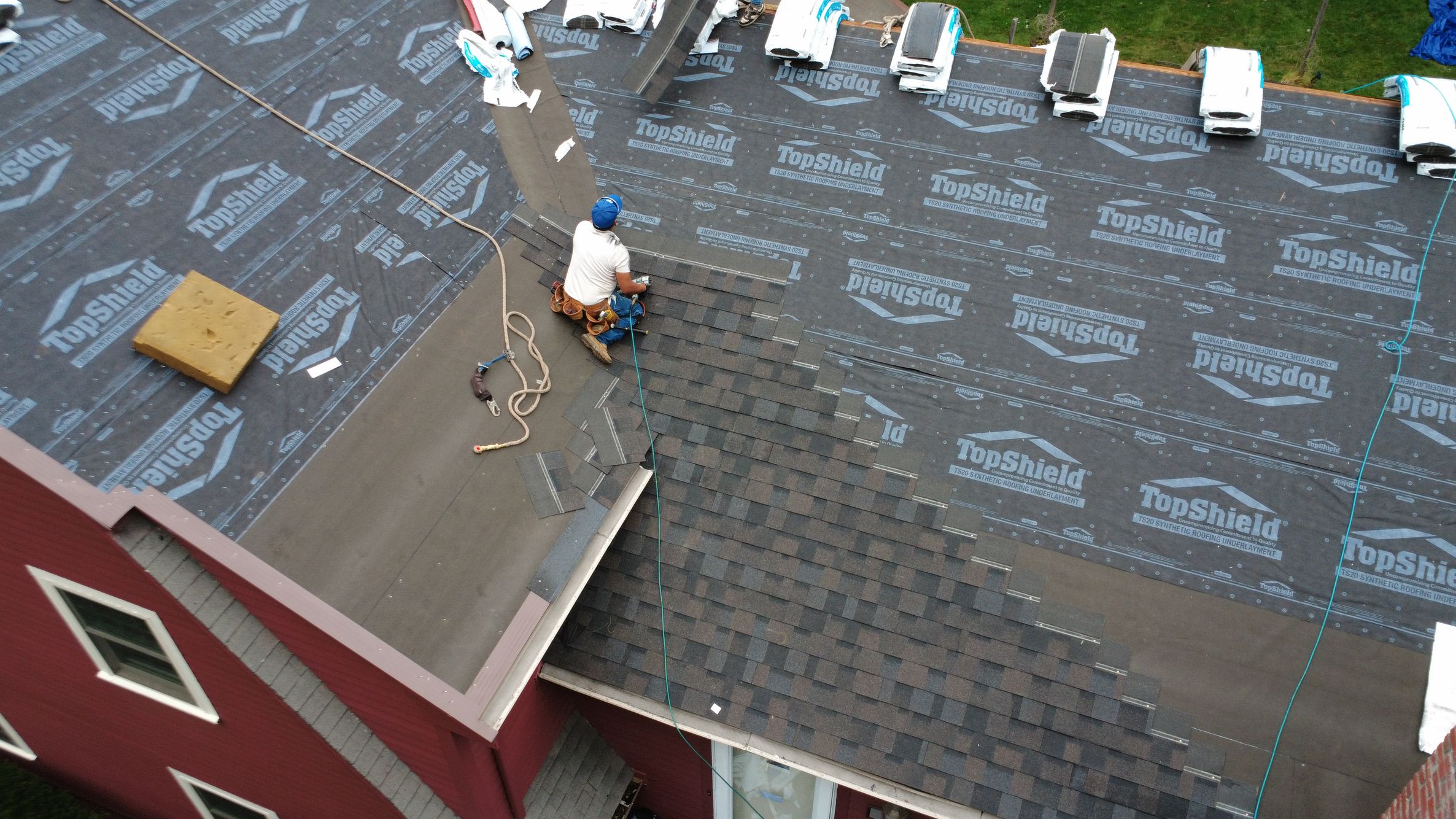 Natarelli & Son Roofing and Gutters crew working - Drone view of in progress roof installation on Locust Lane in Needham MA Drone view of in progress roof installation on Locust Lane in Needham MA