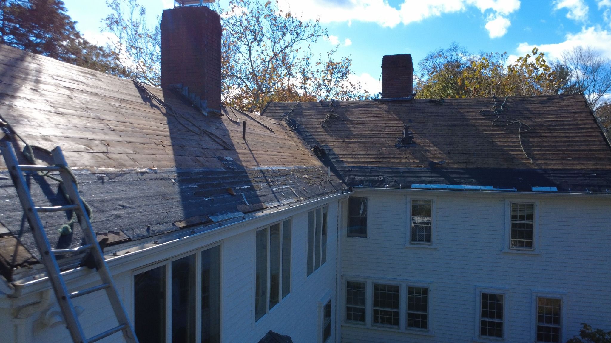 Roofing work in progress on the historic Samuel Dunton House in Norfolk, Massachusetts Roof in progress on an 18th-century historic property in Norfolk, MA