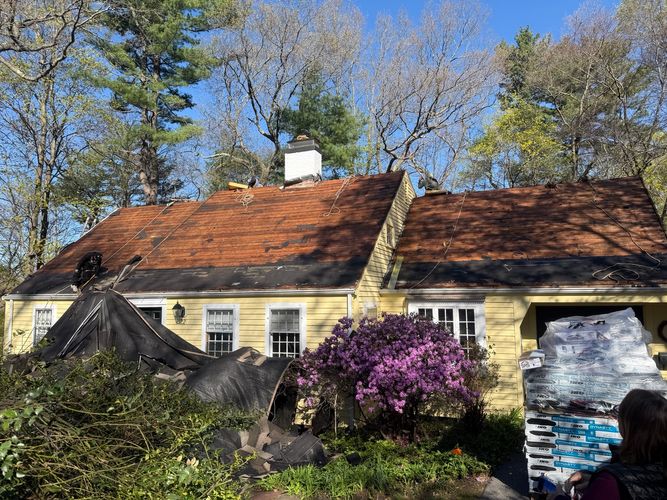 Inspecting clean plywood roof decking during a local roofing replacement project in Wellesley MA.