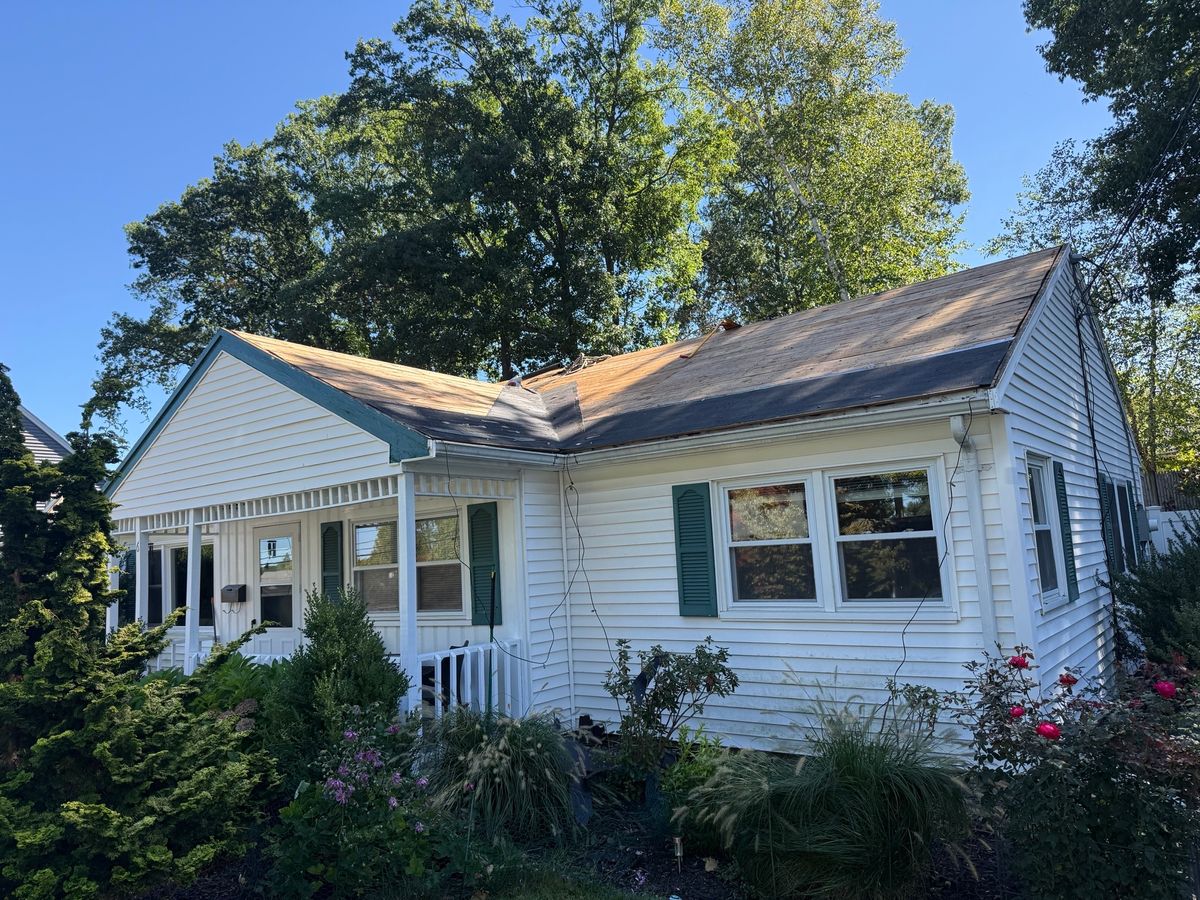 Front of house roof tear-off, prepping for installation of new architectural shingles in Natick, MA by Natarelli & Son Roofing and Gutters