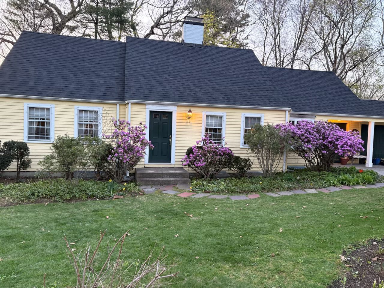 Newly completed IKO architectural shingle roof installation on a cape style house in Wellesley MA.