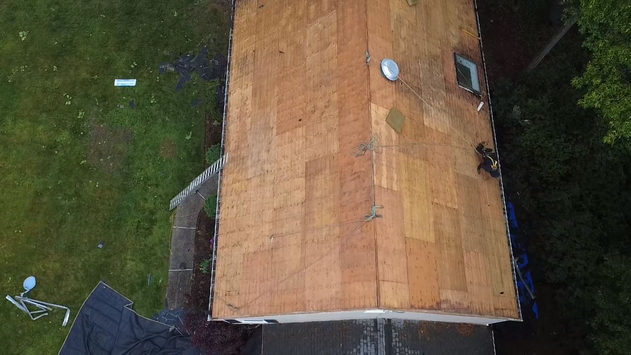 Roofing contractors fully stripped shingle residential roof in Walpole MA