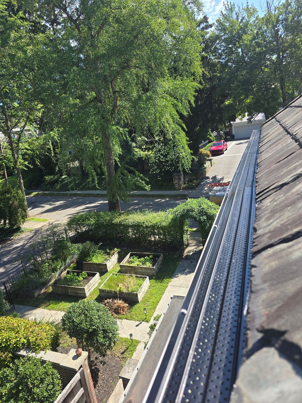 Gutter tune-up and leaf guard protection installation on a residential home at 405 Commonwealth Ave in Newton, MA.