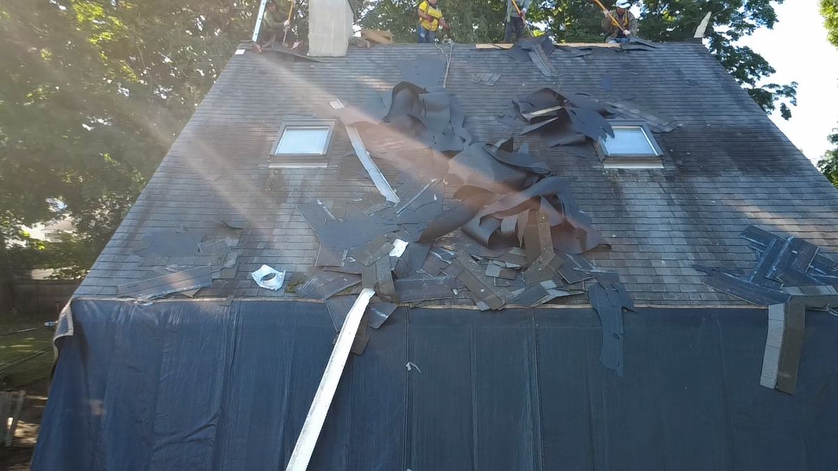 Aerial drone view of a asphalt shingle roof replacement in progress by Natarelli & Son Roofing and Gutters in Natick, MA.