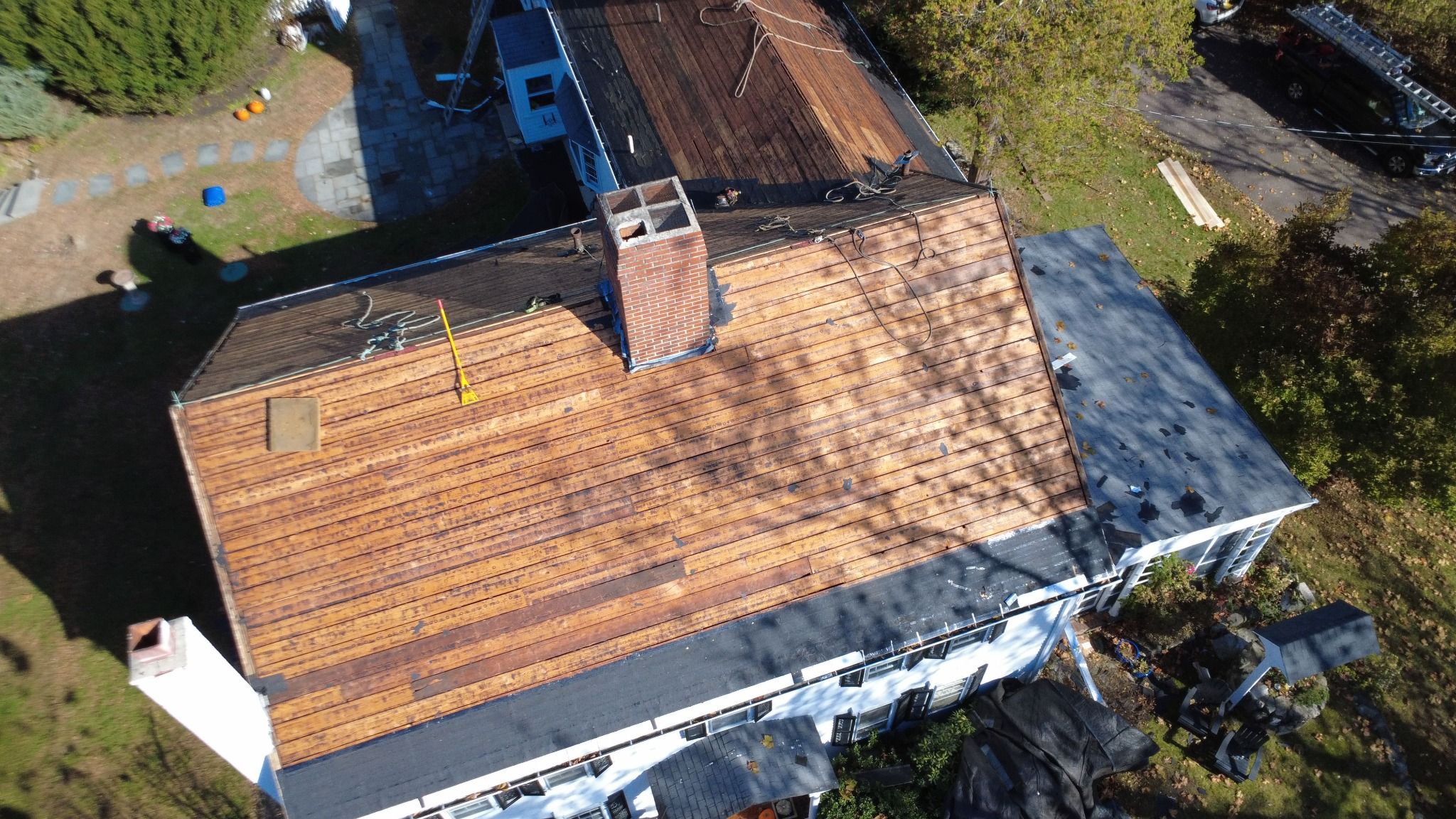 Overhead view of Residential roofing work on an 18th-century historic property called the Samuel Dunton House in Norfolk, MA Residential roofing work on an 18th-century historic property called the Samuel Dunton House in Norfolk, MA