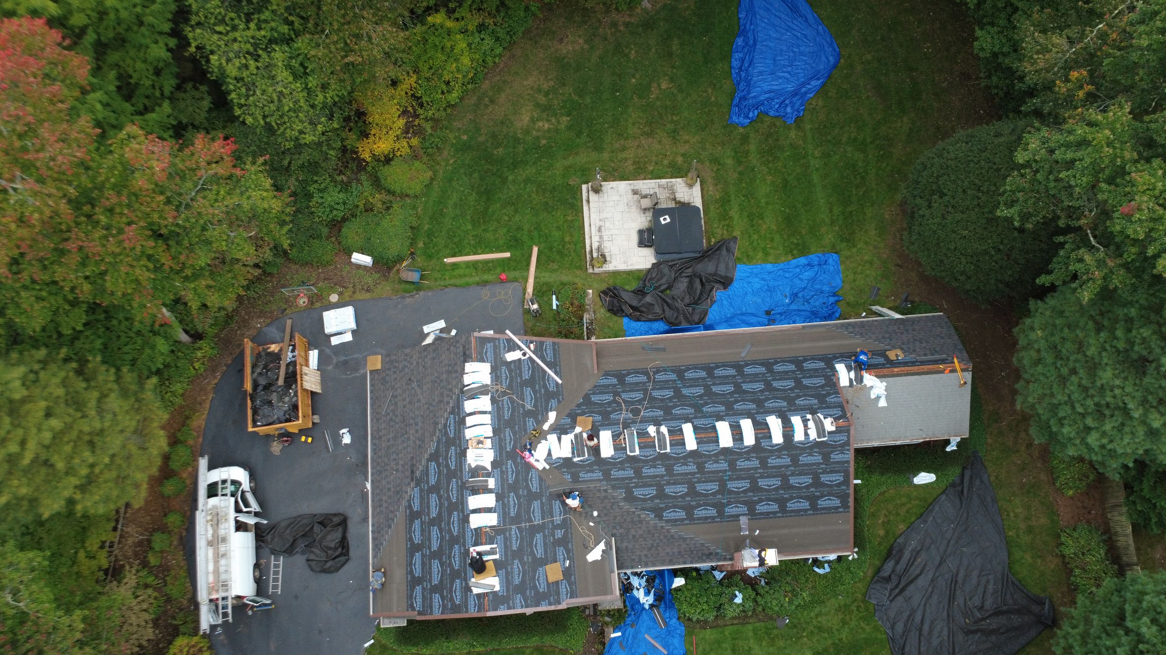 Natarelli & Son Roofing and Gutters at work on roof on Locust Lane in Needham MA Drone top down view of roof installation on Locust Lane in Needham MA