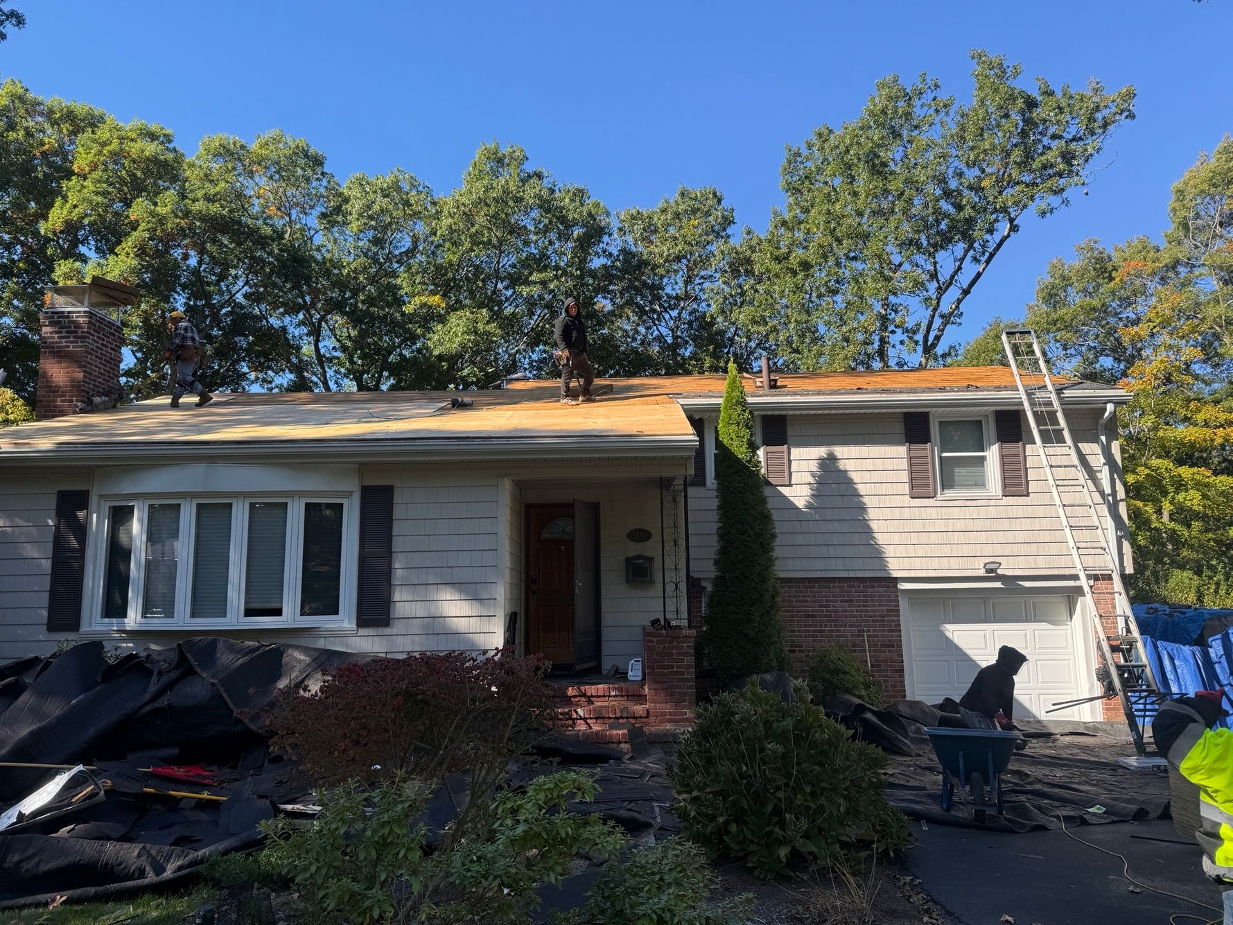 Crew on roof installing ice & water shield 