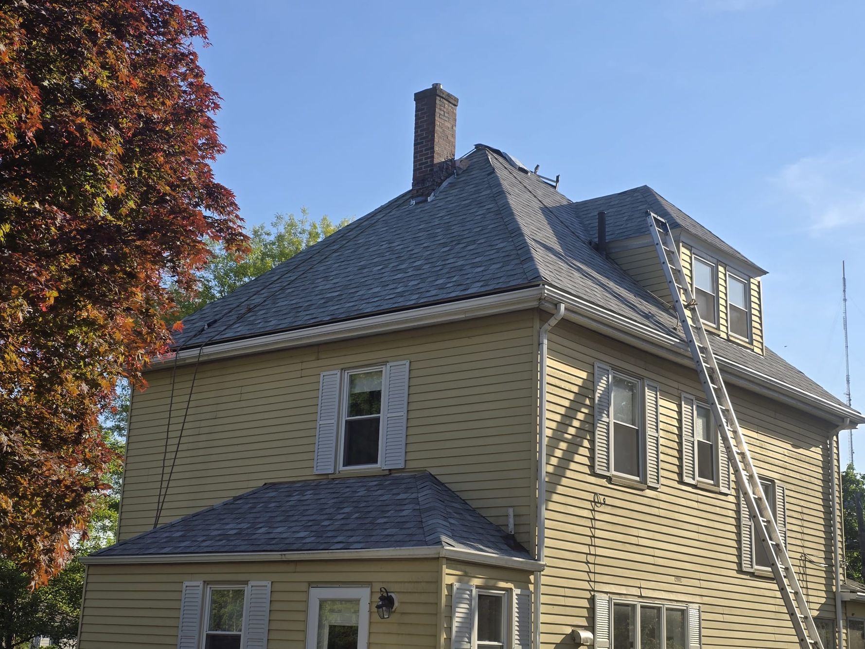 A work in Newton's Historic District installing new architectural shingles and skylights.