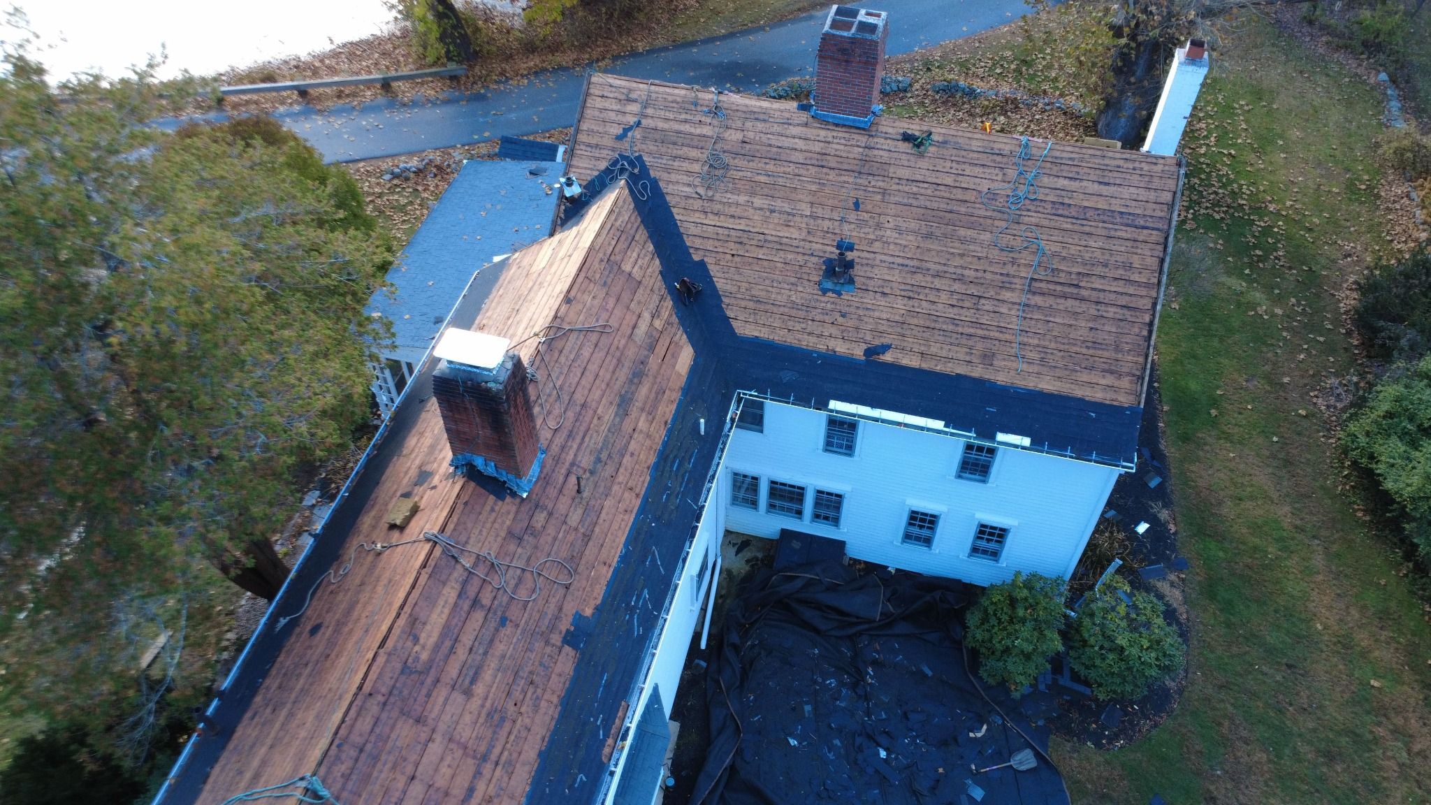 Aerial view of Exposed roof decking during historic home roof replacement in Norfolk, MA Exposed roof decking during historic home roof replacement in Norfolk, MA