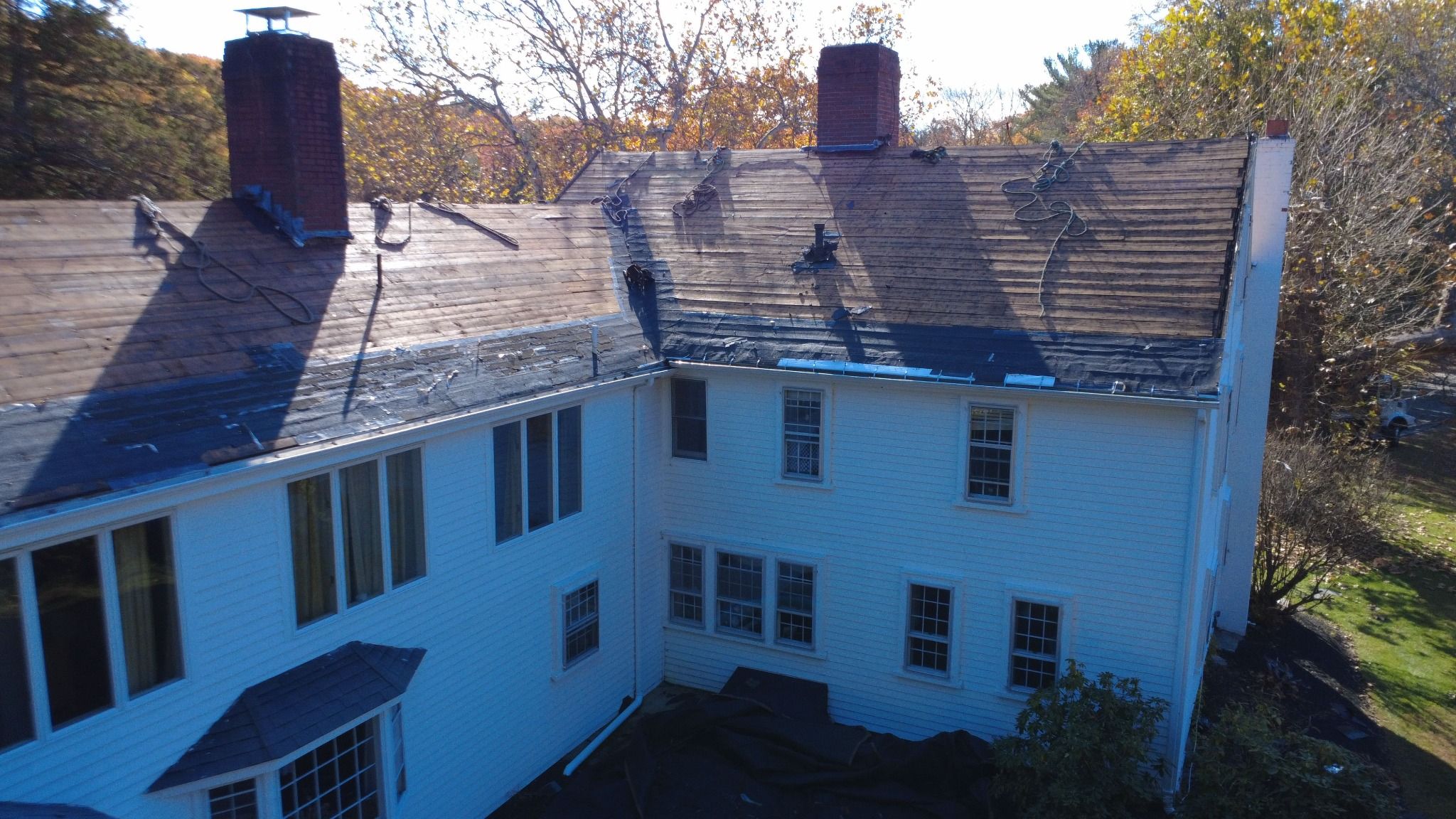 Rear view of Natarelli & Son Roofing and Gutters on a residential roofing work on an 18th-century historic property in Norfolk, MA Natarelli & Son Roofing and Gutters on a residential roofing work on an 18th-century historic property in Norfolk, MA