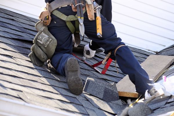 A person installing shingles 