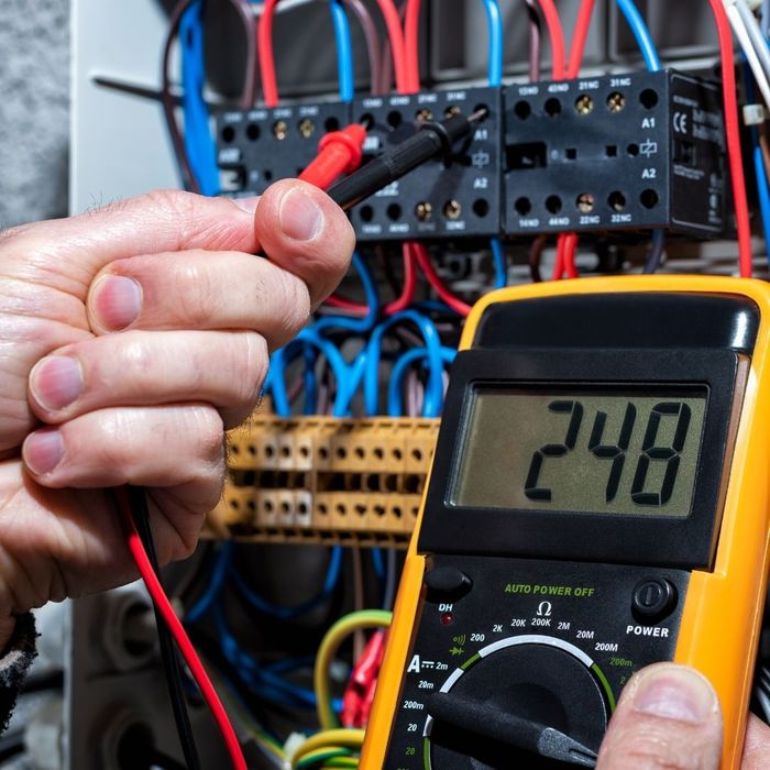 electrician testing electrical panel