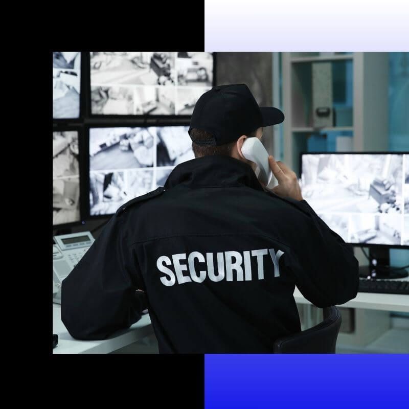 security guard looking at security monitors
