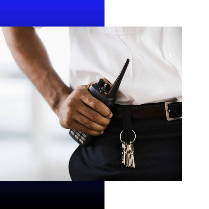 security guard with his hand on his radio