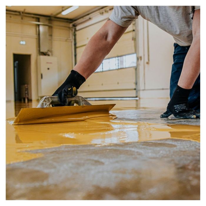 epoxy coating being applied to garage floor