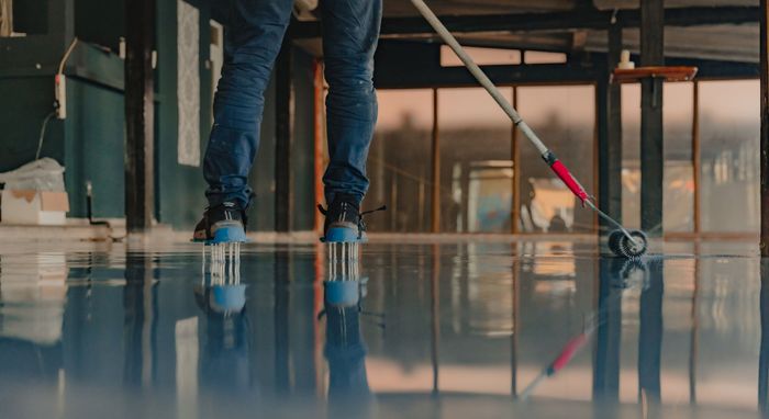 applying epoxy coating in garage