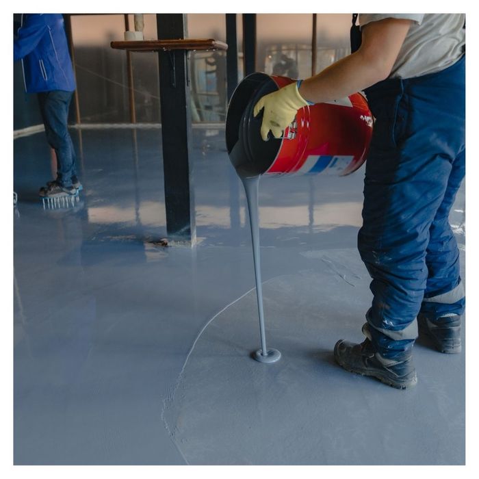 pouring epoxy coating in garage