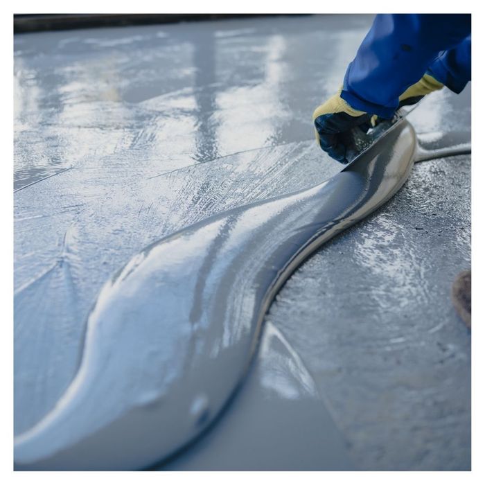 applying epoxy coating in garage