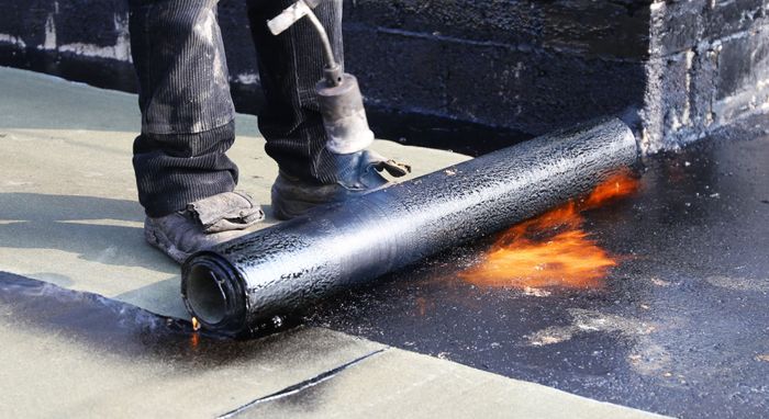 concrete seal being applied with roller