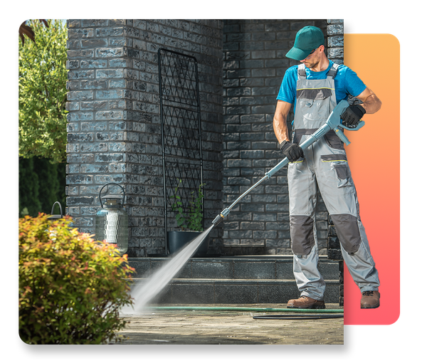 man pressure washing sidewalk