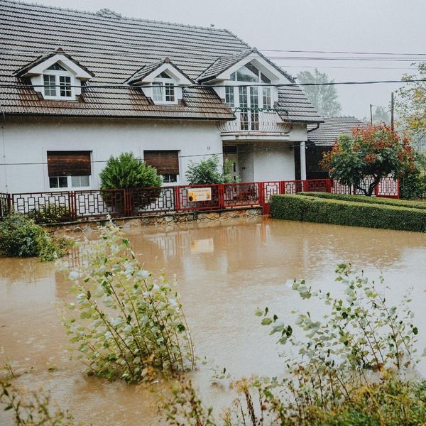 high flood waters against house high flood waters against house
