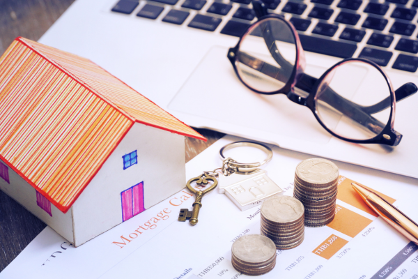 toy house, coins, glasses, and a key. 