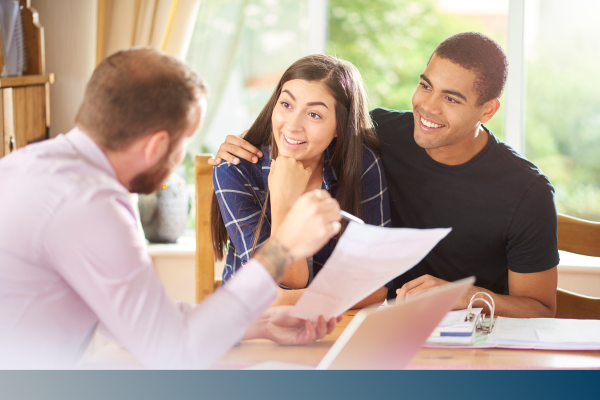 couple conversing with a mortgage lender. 