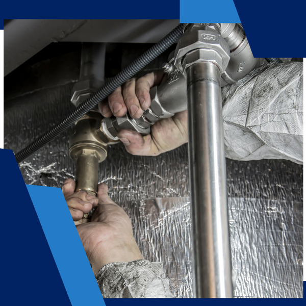 plumber working on piping