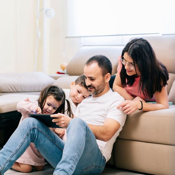 happy family look at tablet
