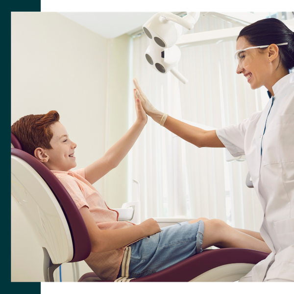 young patient high fiving dentist young patient high fiving dentist