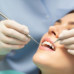 A periodontist's hands gently examining a patient's gums. A periodontist's hands gently examining a patient's gums.