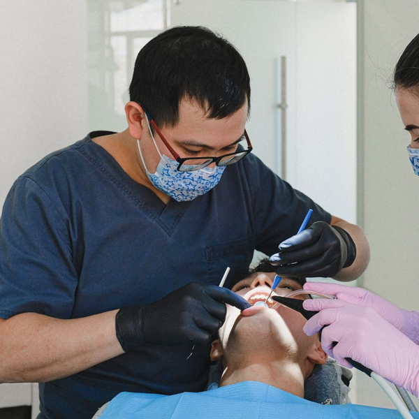 patient in chair getting deep teeth cleaning 