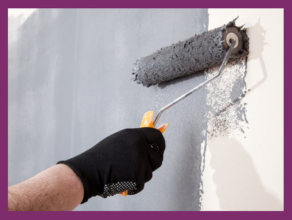 Paint roller painting a room