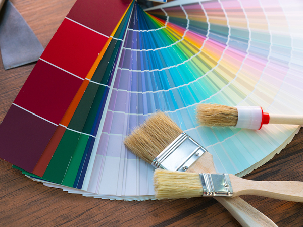 Image of color samples and paint brushes for painting a house. 