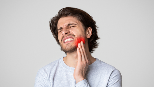 Man holds hurting jaw
