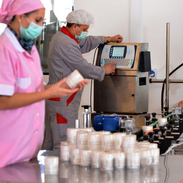 Pharma employees working with a machine