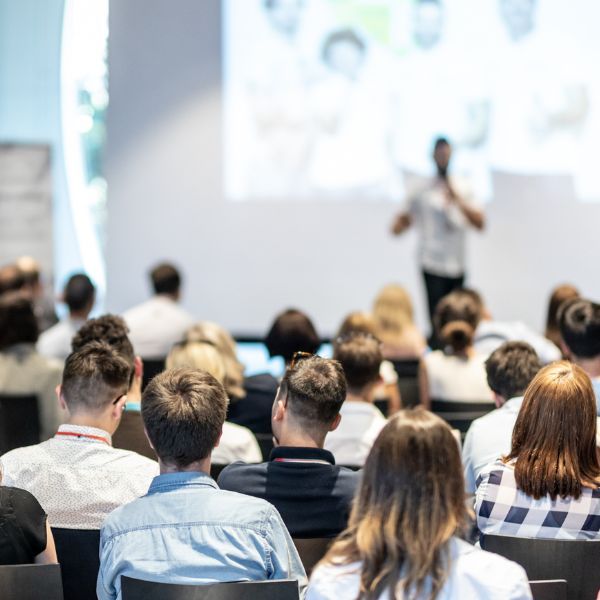 people in conference room looking at presentation