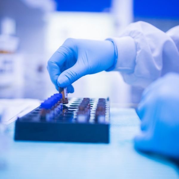 close up of lab scientist putting away samples