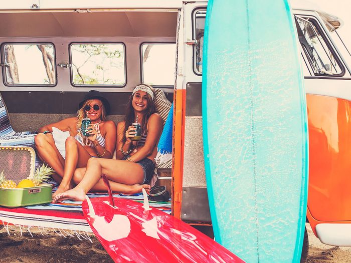 Young Surfer Girls Having Fun Hanging Out in Vintage Surf Van.