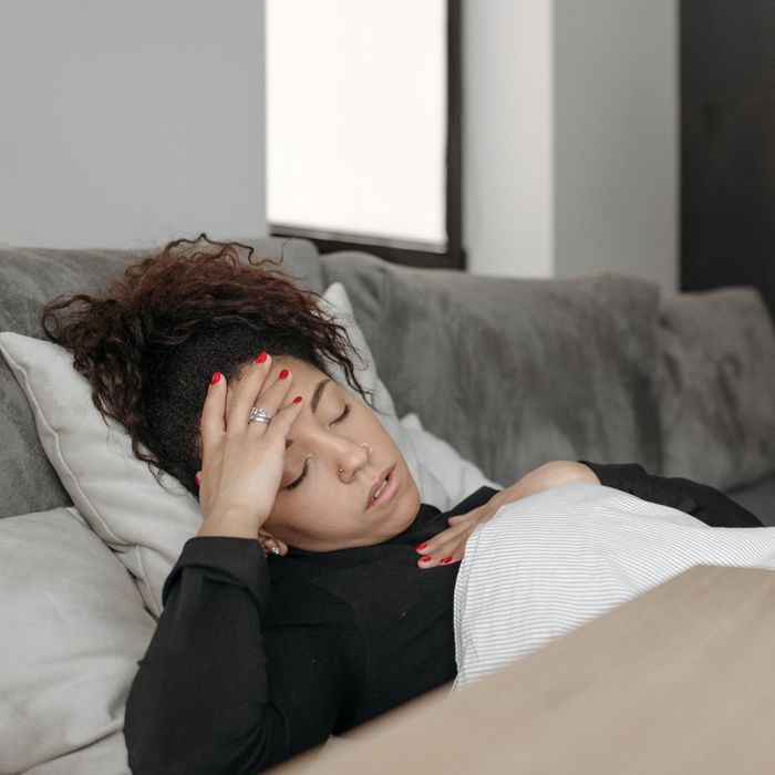 A sick woman laying in bed