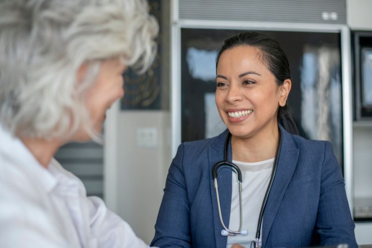 Doctor smiling while talking to a patient