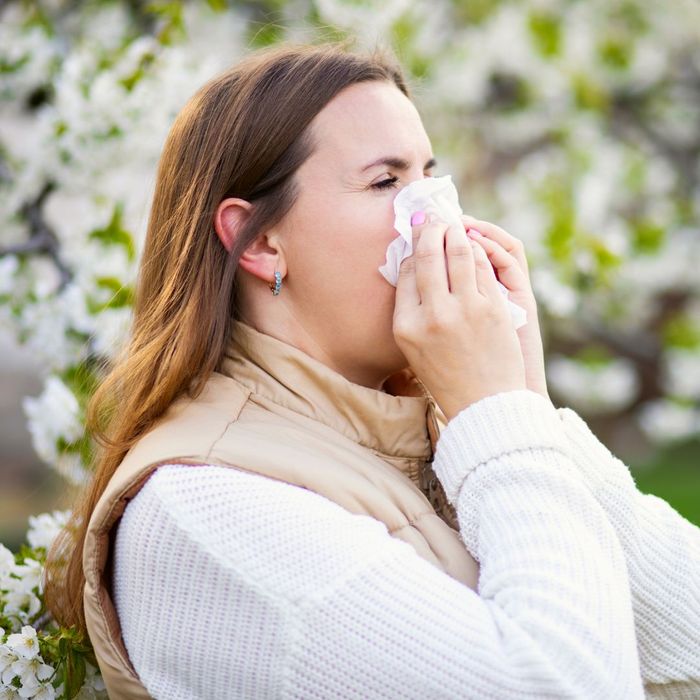 A woman sneezing