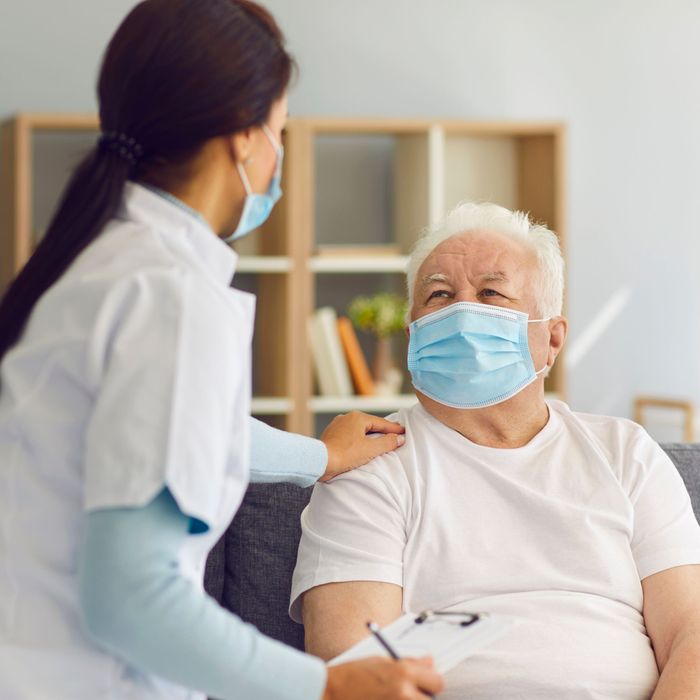 Old man speaking with nurse