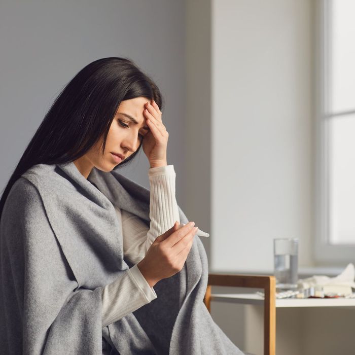 A women measuring her temperature