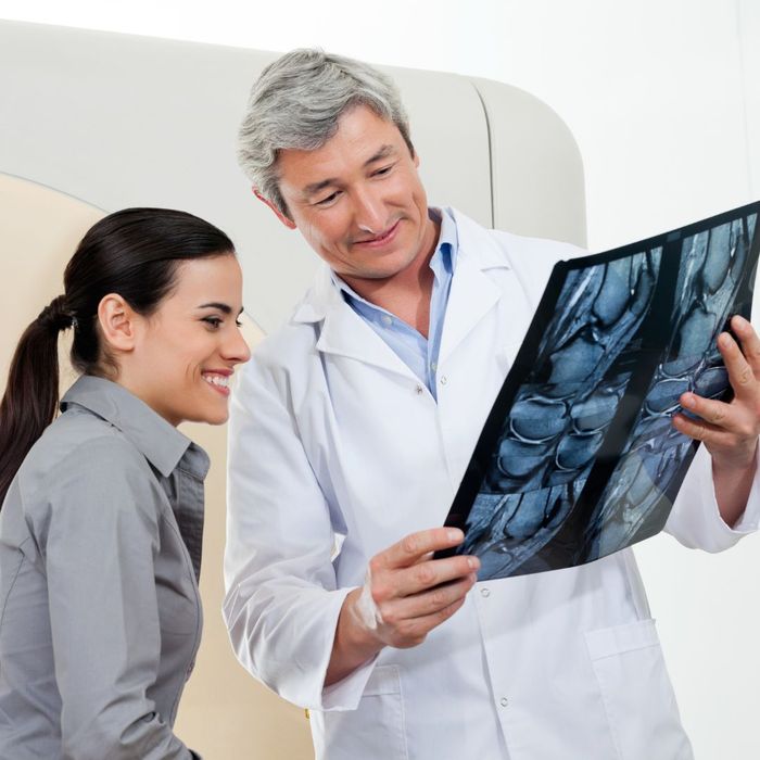 doctor inspecting x-ray with patient