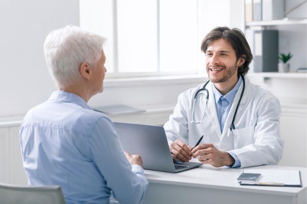 elderly man talking to doctor