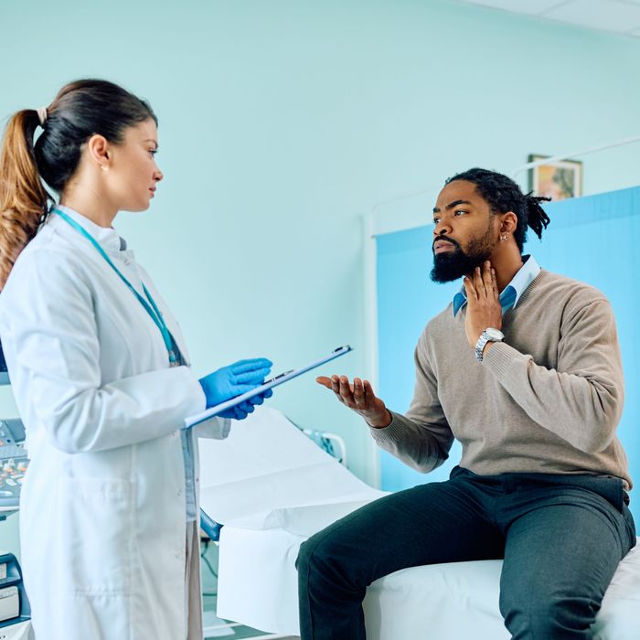 Patient speaking to doctor about sore throat