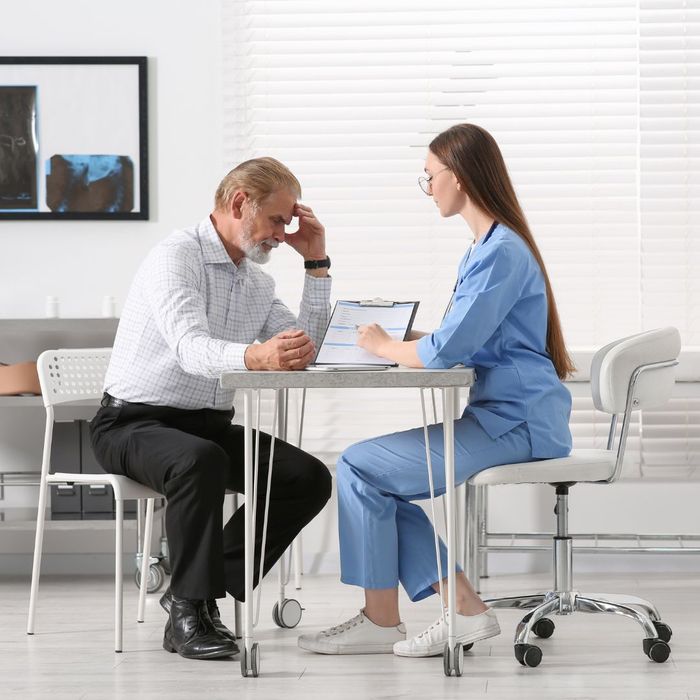 A man speaking to a nurse