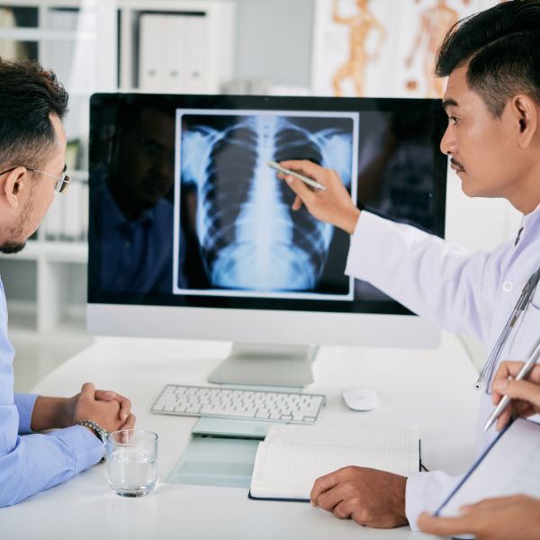 A doctor going over an x ray with their patient 