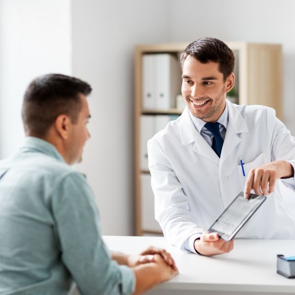 A happy doctor speaking with his patient 